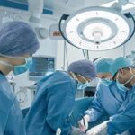 Surgeons performing surgery under bright operating lights