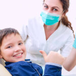 Young boy smiling in dentist's chair